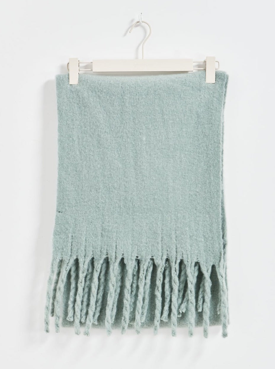 Light blue scarf with fringe on a white background