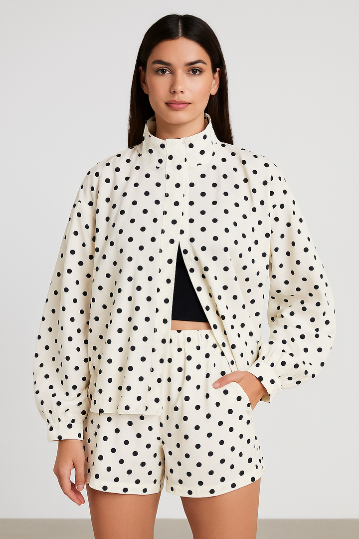 Woman wearing a polka dot outfit with a white background
